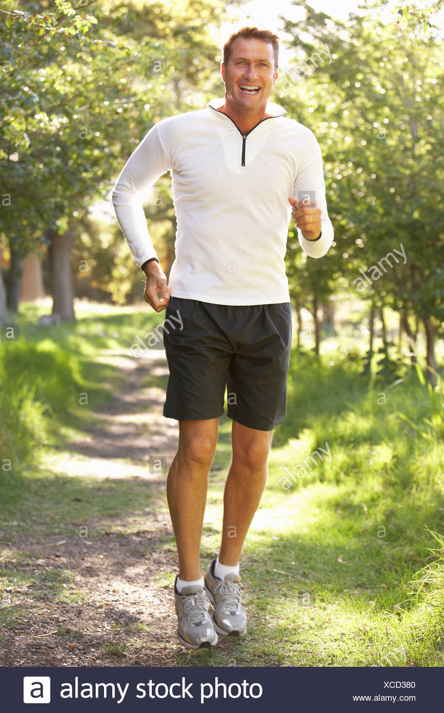 Middle aged Man Jogging In Park Banque D'Images
