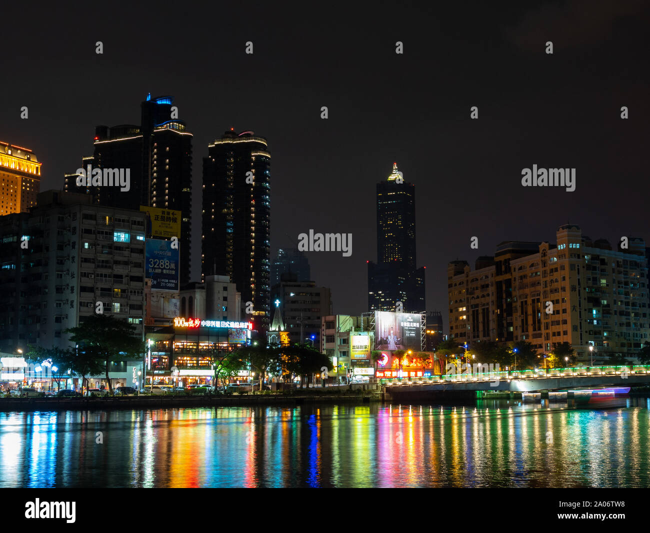 Le luci colorate della città di Kaohsiung (Taiwan) e la sua famosa torre 85 grattacielo riflettendo in acqua di fiume dell'amore di notte Foto Stock