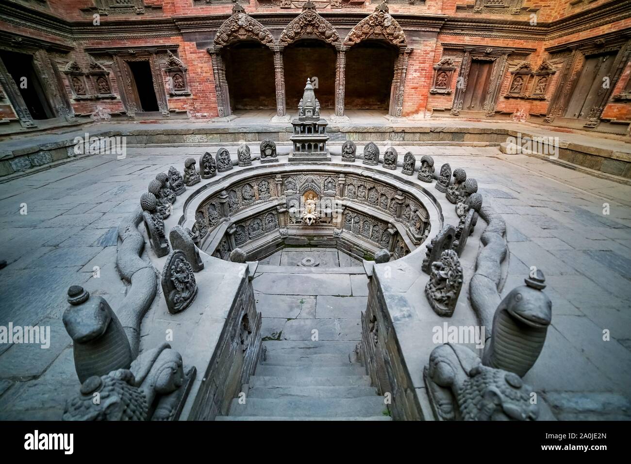 Nepalese in stile tradizionale di finestre, porte e sculture in legno sulle mura di un antico palazzo. Foto Stock