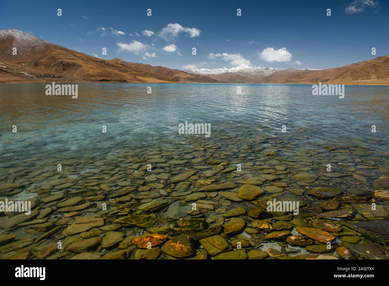 Grandi rocce sotto l'acqua cristallina di un lago in Tibet, in Cina. Foto Stock