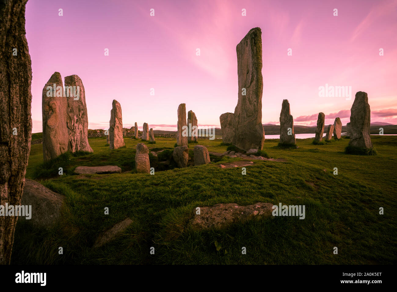 L'anello centrale di Callanish standing di pietre contro un cielo rosa dell'isola di Lewis, Ebridi Esterne, Scotland, Regno Unito Foto Stock