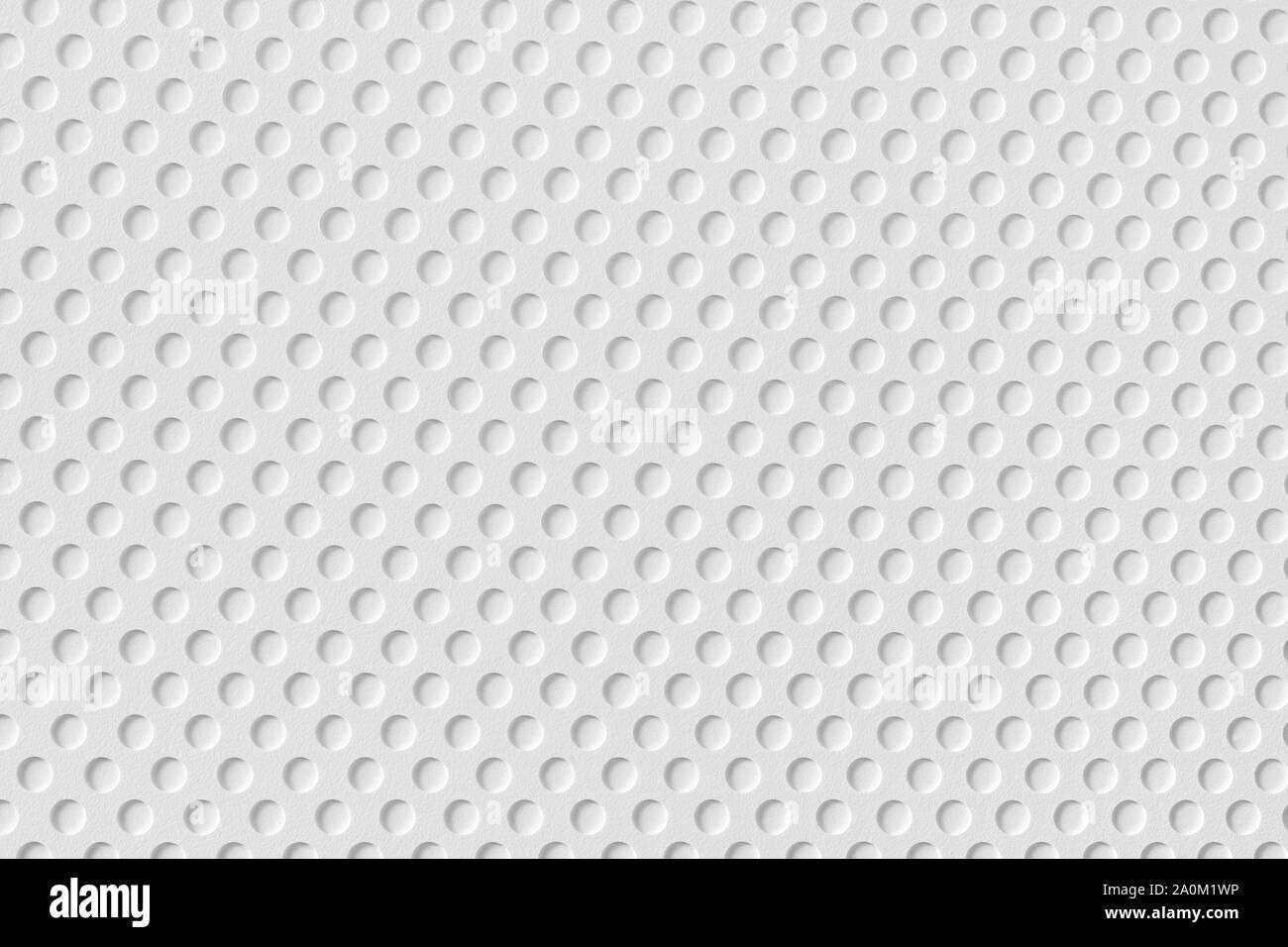 Bianco superficie in plastica con fori tondi pattern. Macro di grande consistenza e lo sfondo Foto Stock