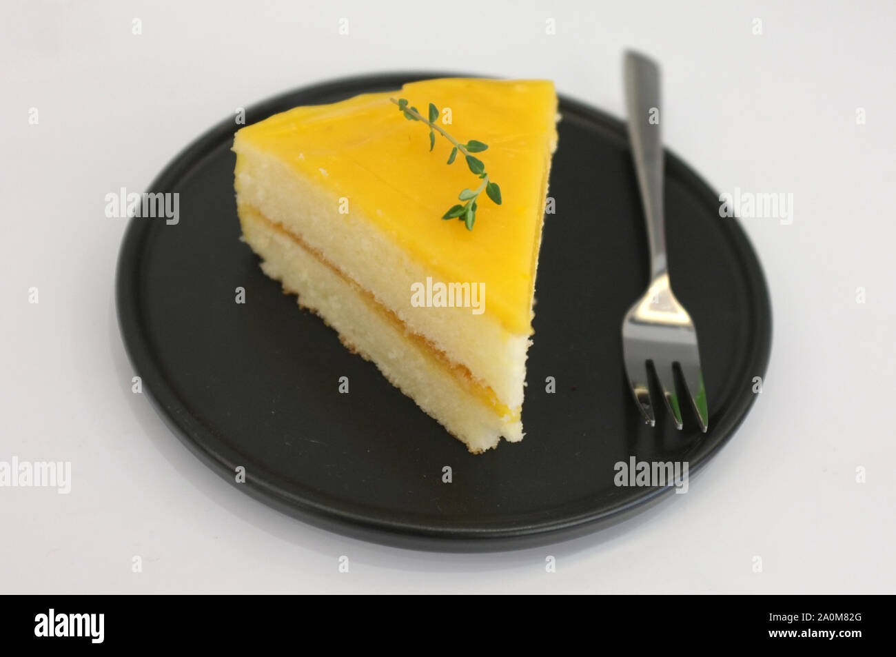 Mousse torta arancione sul piatto nero . Foto Stock