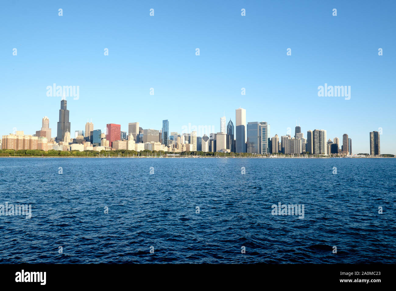Il Chicago, IL skyline si eleva alto sul lago Michigan su una calda mattina autunnale. Foto Stock
