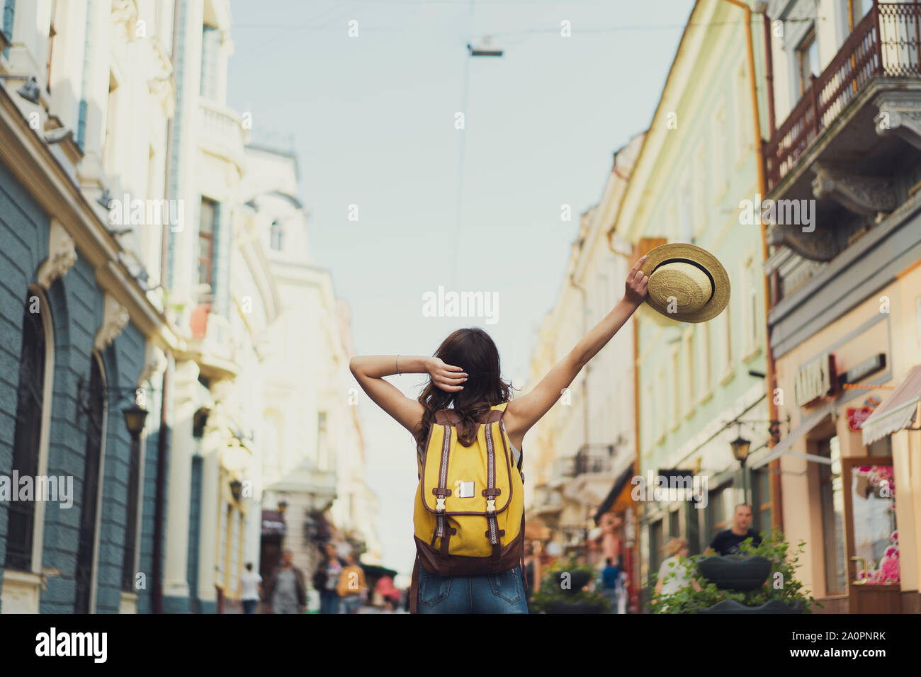 Vista posteriore di una giovane donna viaggiatore con uno zaino sulla sua spalla di visite turistiche in una città straniera, elegante straniero femmina esamina architectural Foto Stock Vista posteriore di una giovane donna viaggiatore con uno zaino sulla sua spalla di visite turistiche in una città straniera, elegante straniero femmina esamina architectural Foto Stock