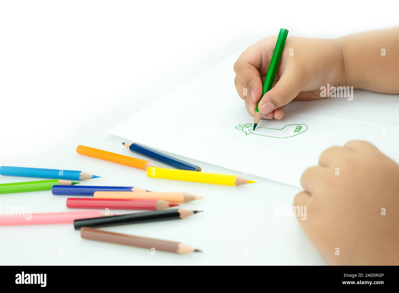 I bambini disegnare le pitture nella sala giochi, un bambino è in possesso  di una matita nelle sue mani alla carta e matite colorate per disegnare sul  tavolo, mano Kids disegni, chi