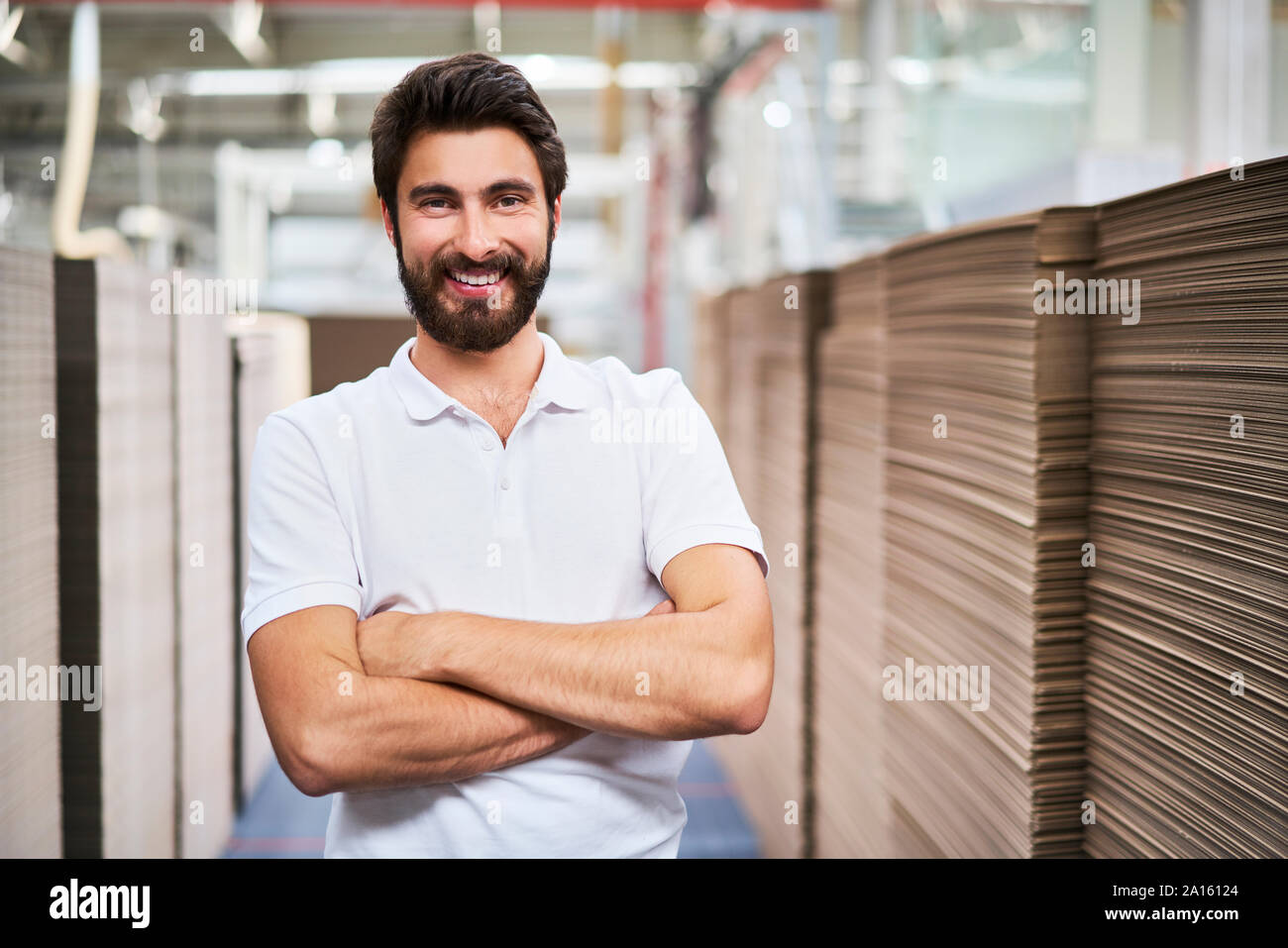 Ritratto di uomo sorridente in sala di fabbrica Foto Stock