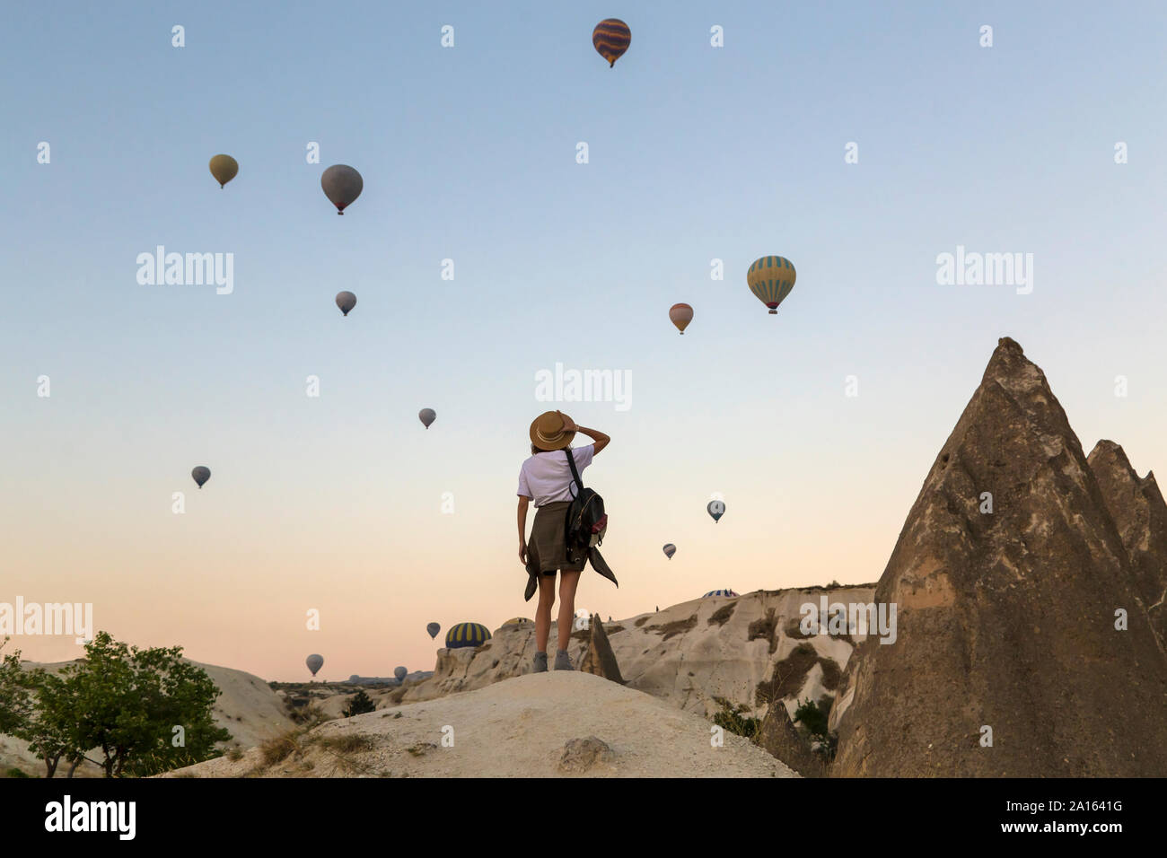 Giovane donna e aria calda ballons, Goreme, Cappadocia, Turchia Foto Stock