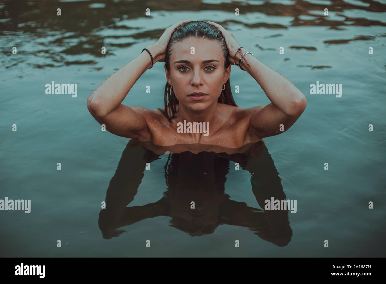 Ritratto di giovane donna bionda di balneazione in un lago Foto Stock