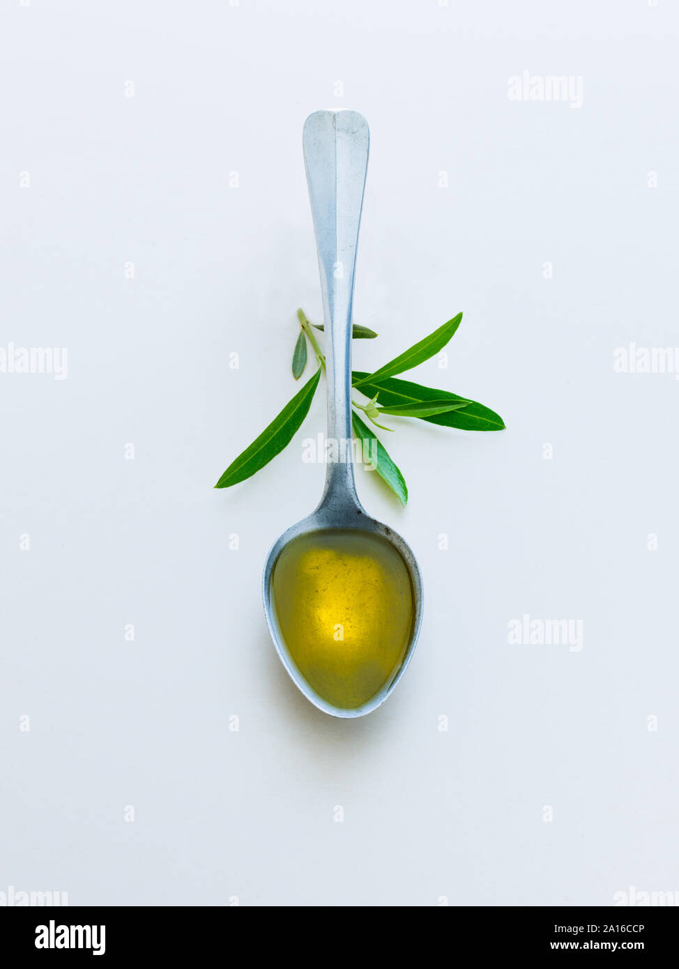 1 cucchiaio di olio di oliva con foglie di olivo Foto Stock