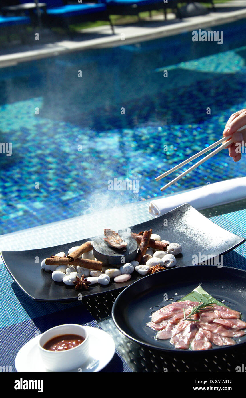 Cibo asiatico prepara sul blu piscina background in Hua Hin Foto Stock