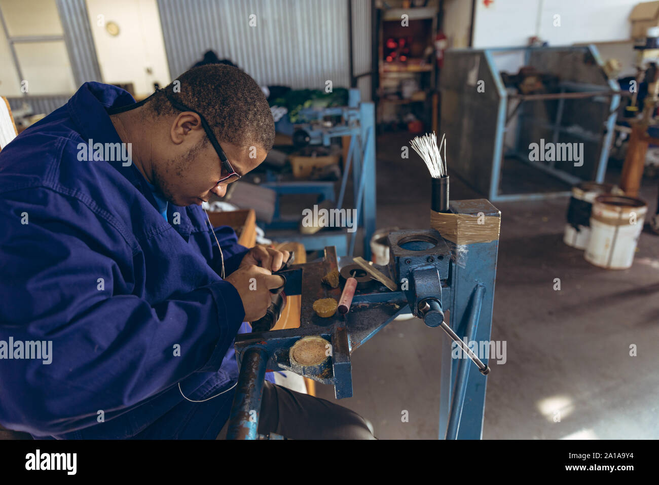 Giovane uomo che lavora in un equipaggiamento sportivo factory Foto Stock