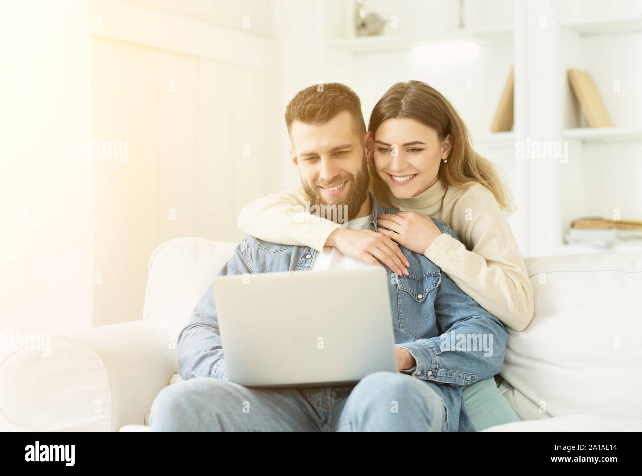 Felice coppia avente video-chiamata sul laptop, trascorrendo il tempo a casa Foto Stock