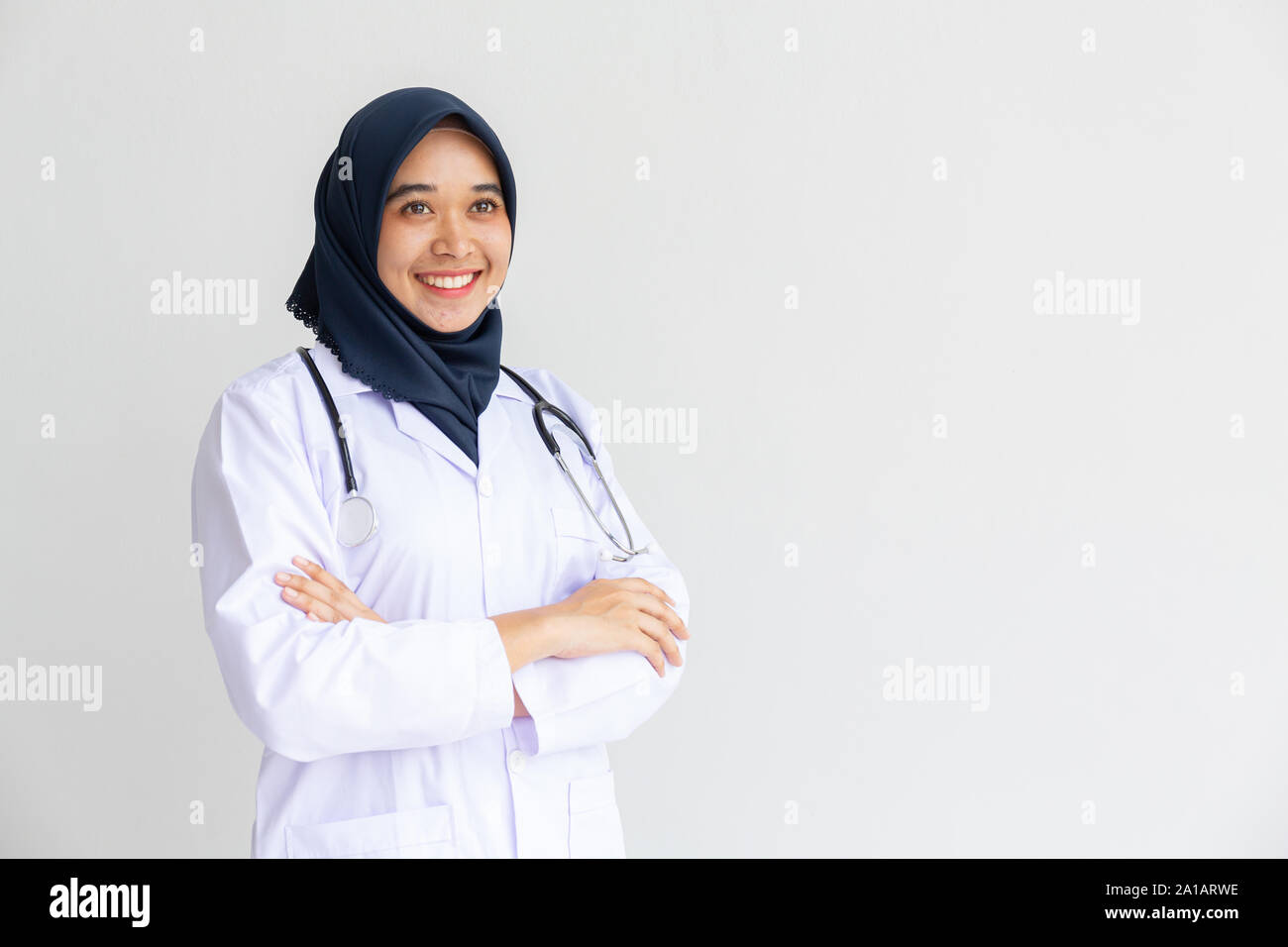 Giovani Musulmani arabi intern medico donne sorriso sulle labbra per isolare lo sfondo bianco concetto per l'Islam persone che lavorano in ospedale medico health care, infermiera moderno Foto Stock
