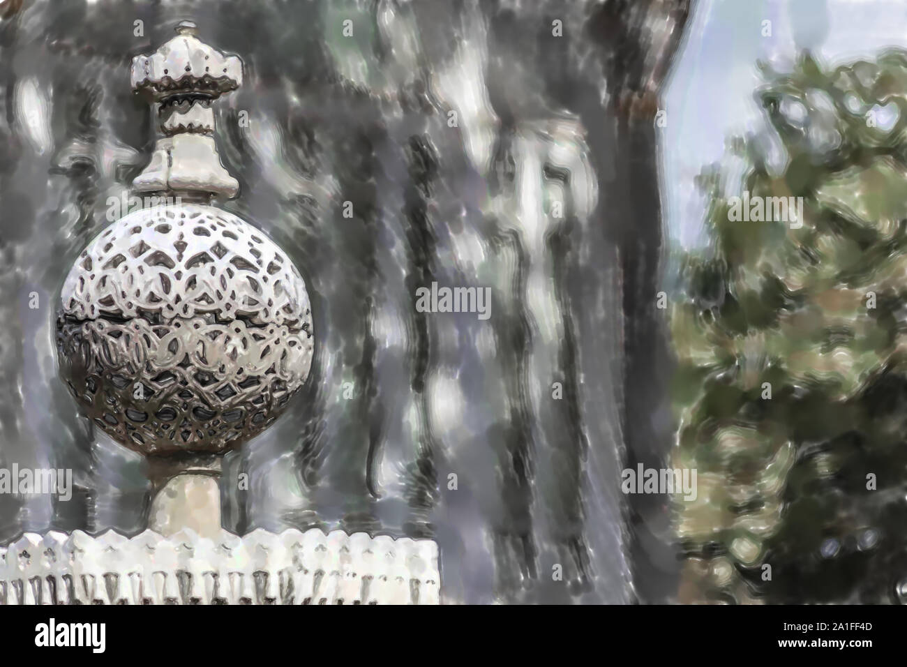 Acquerello immagine: Cisiliated sfera in pietra con belle incisioni in corrispondenza della punta di una recinzione. Foto Stock