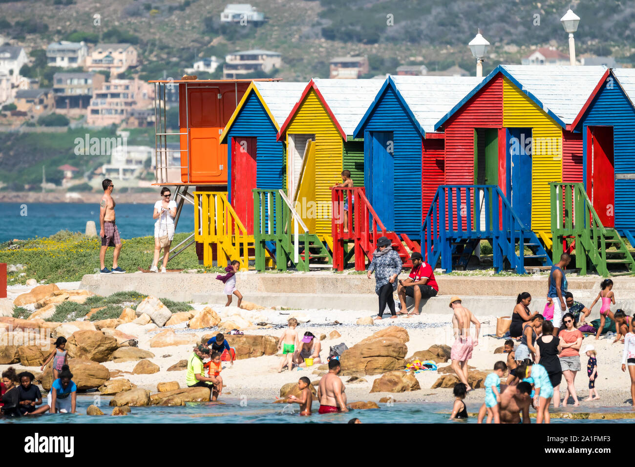 Primo piano o close up della pittoresca spiaggia di capanne e beachgoers o le persone che si godono il sole estivo presso il St James, Cape Peninsula, Cape Town, Sud Africa Foto Stock