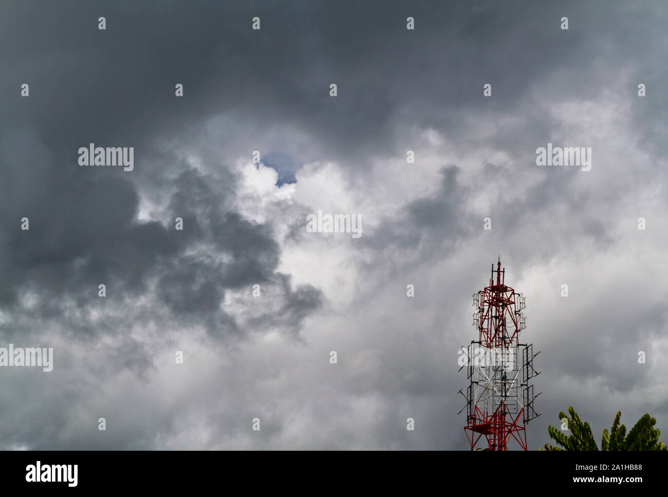 Vista di una torre radio contro il cielo con dark cloud Foto Stock