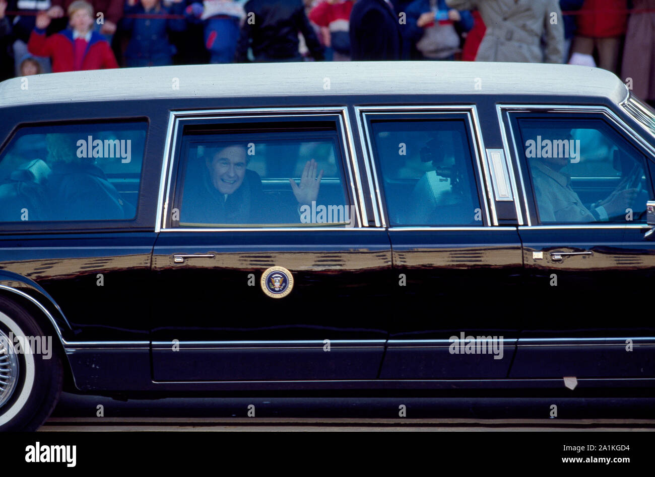 Nuovo presidente George H.W. Boccola in automobile presidenziale, salutando la folla in Pennsylvania Avenue durante la sua sfilata inaugurale il 20 gennaio 1989, Washington, D.C. Foto Stock