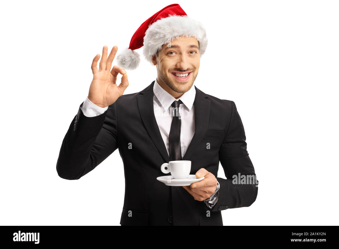 Imprenditore con un cappello di Natale tenendo una tazza di caffè espresso e di gesti perfetti isolato su sfondo whote Foto Stock