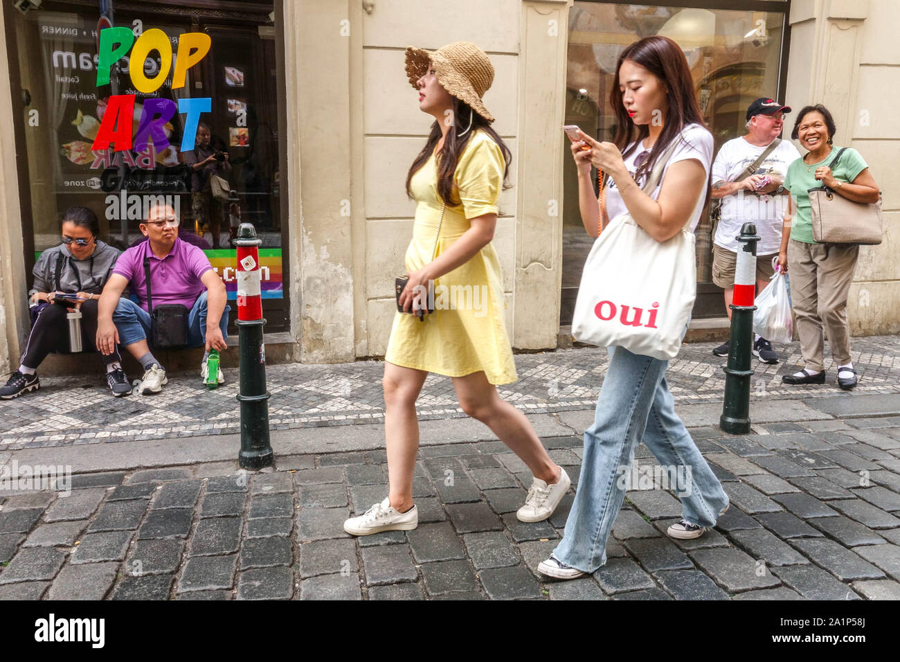 Gente che cammina città, giovani turisti asiatici che camminano in via Charles Praga Turismo nella città vecchia Repubblica Ceca Praga via Karlova giovani donne Foto Stock