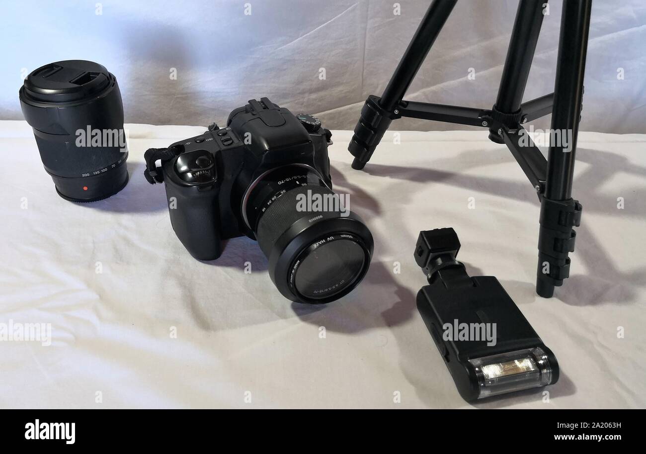 Fotografo fotocamera, lente e gadget su sfondo bianco Foto Stock