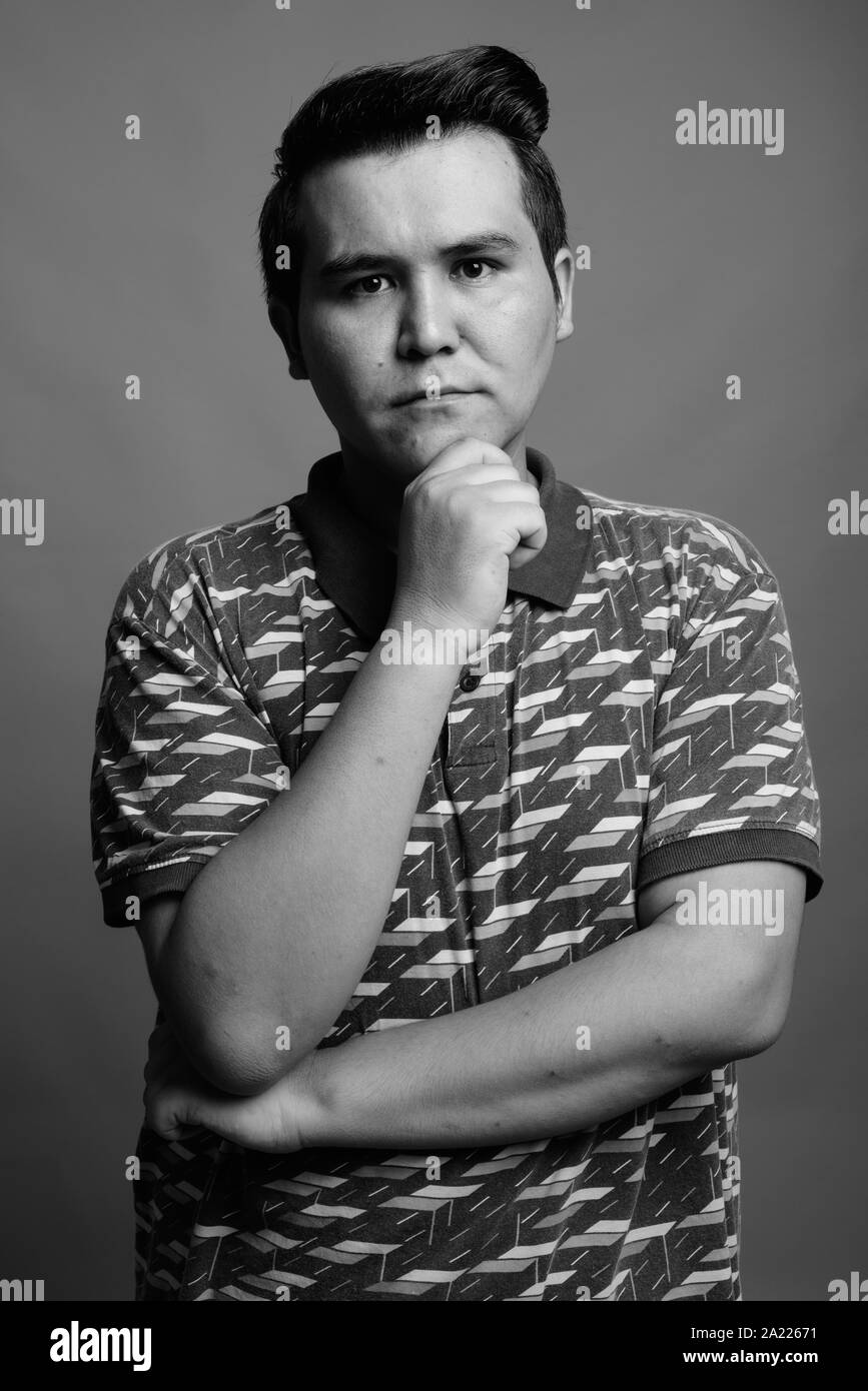 Giovani multi etnico uomo contro uno sfondo grigio Foto Stock