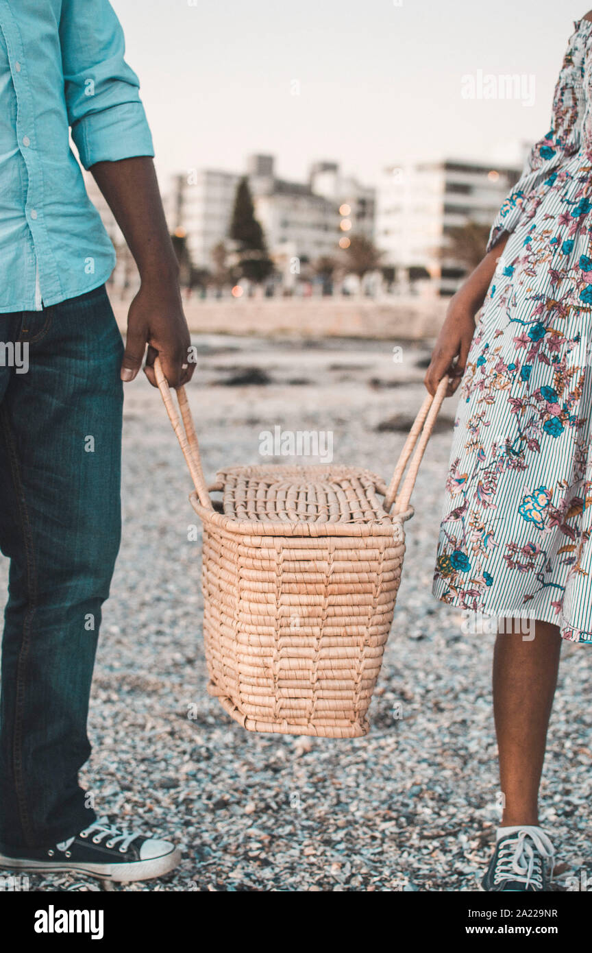 Coppia giovane avente picnic nella spiaggia Foto Stock
