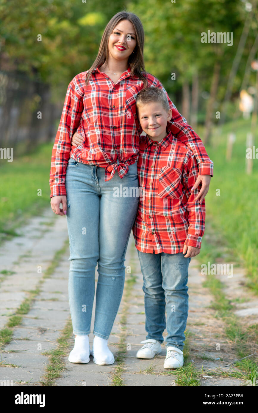 Bella la madre e il figlio sono in piedi e abbracciando su di una pista in un parco. Foto Stock