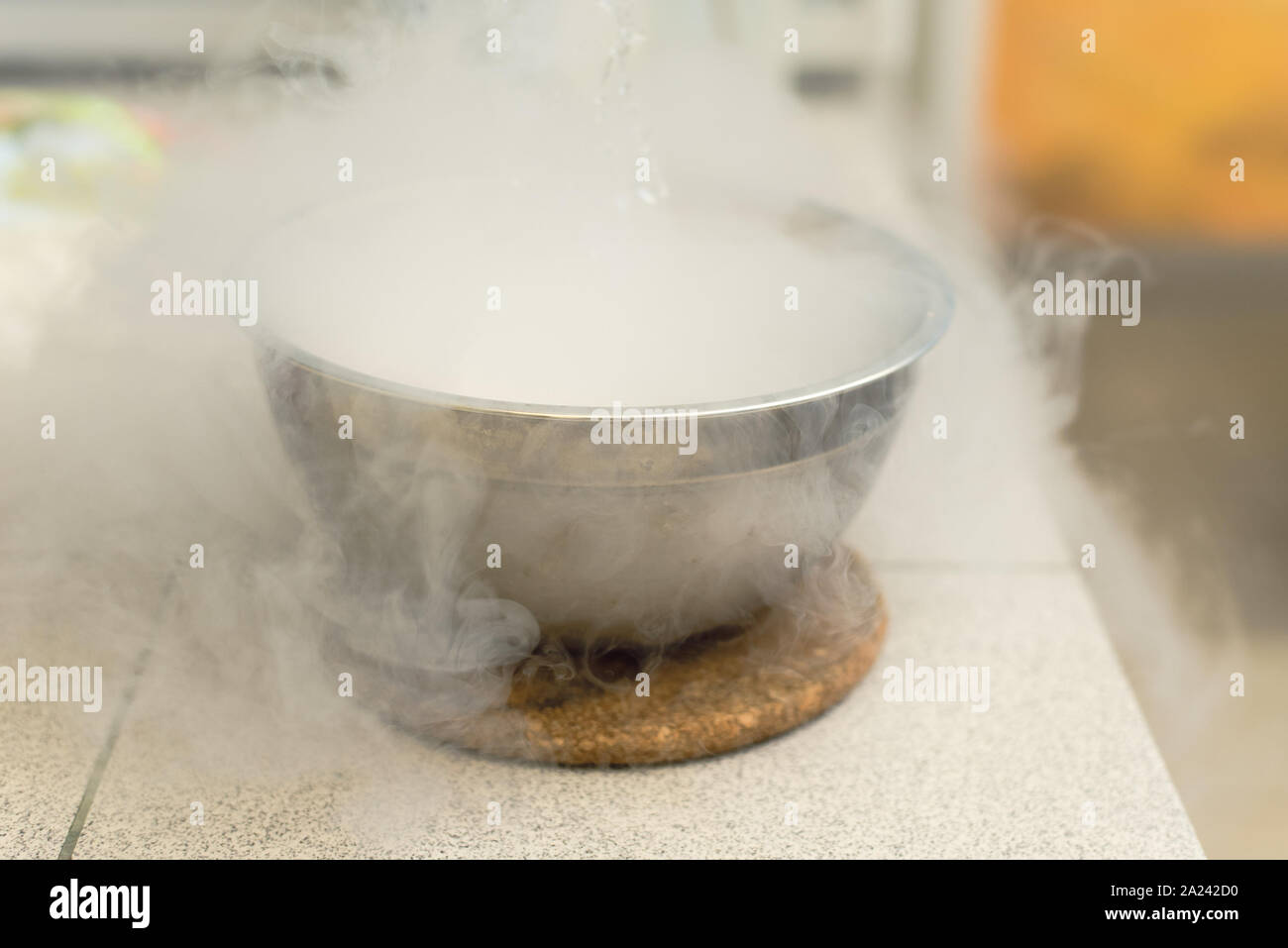 Il fumo proveniente da azoto liquido in un recipiente di metallo. Gli esperimenti di laboratorio con azoto liquido. Foto Stock
