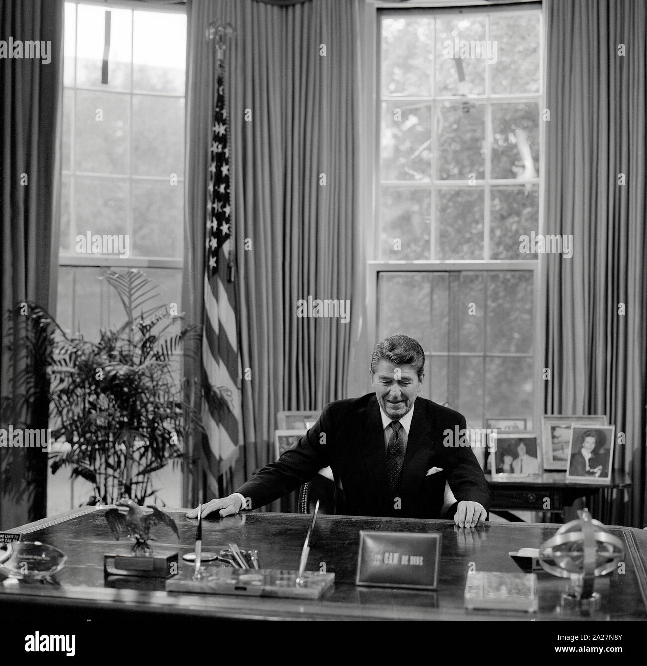 Il Presidente Ronald Reagan alla sua scrivania in ufficio Ovale della Casa Bianca di Washington, D.C. Foto Stock