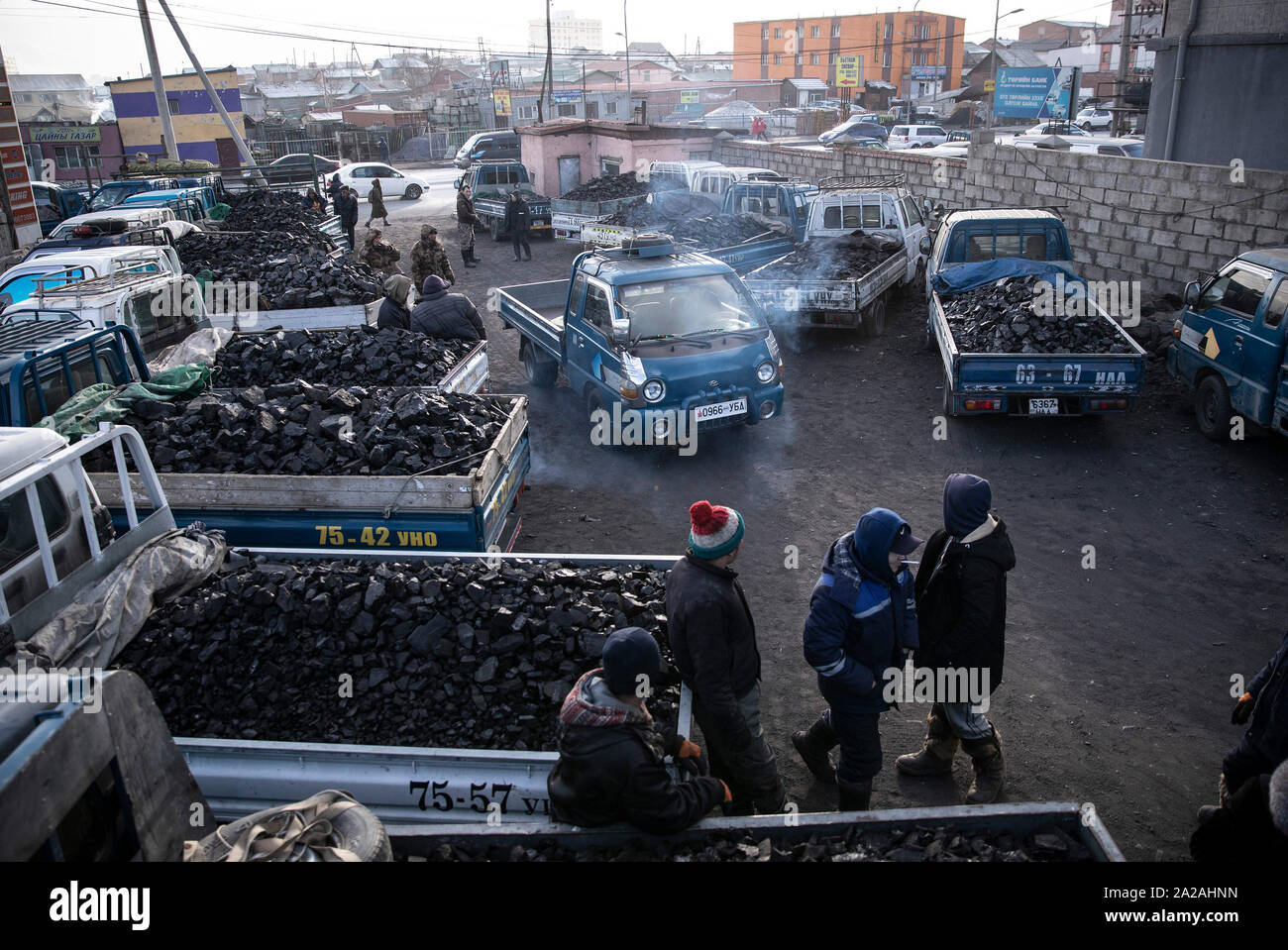 I camion che trasportano materie del carbone per essere venduti ai residenti della capitale Ulaanbataar arriva alla periferia della città, 14 gennaio 2019. Foto Stock