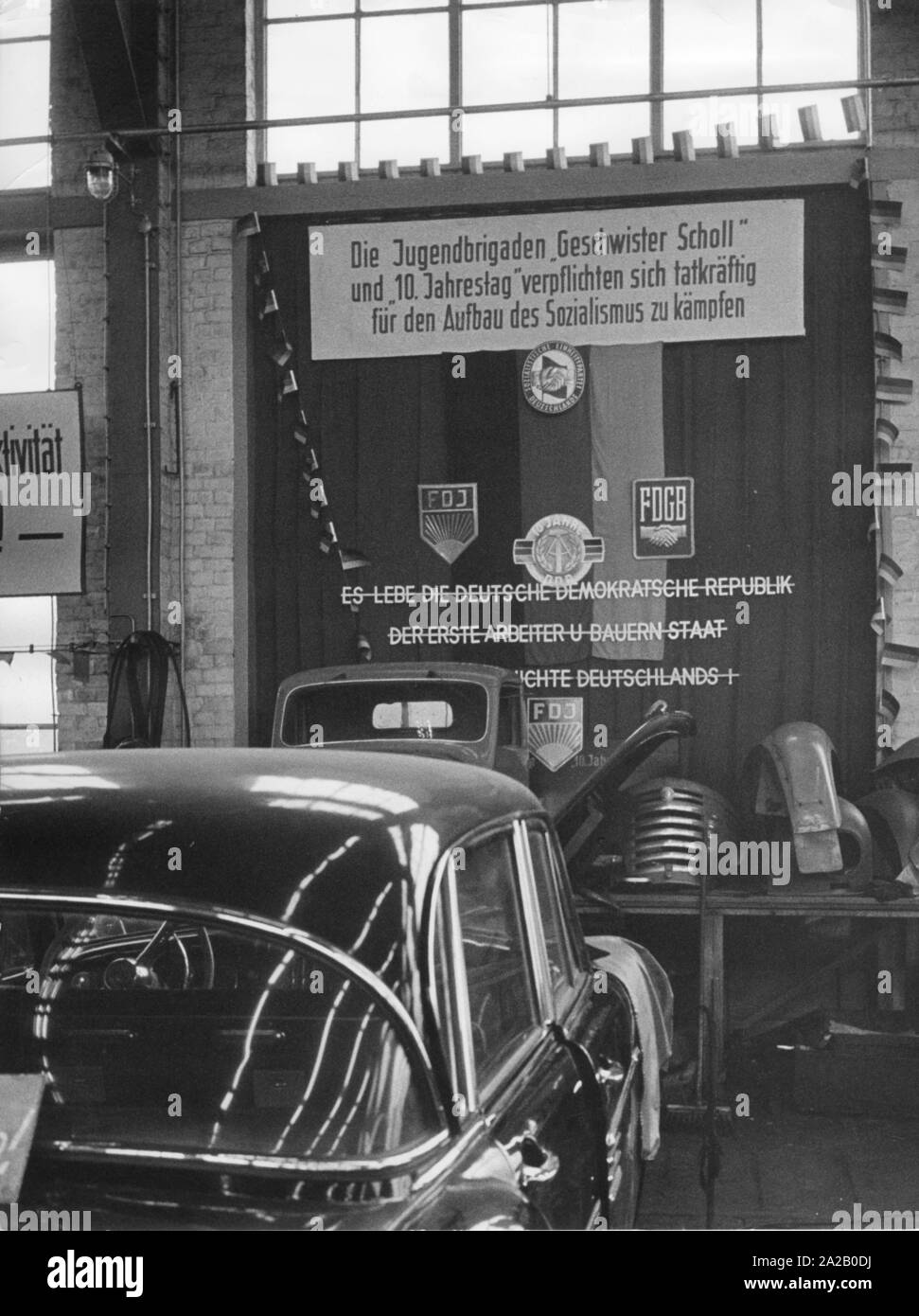Automobile repair shop nel 'Schwarze Pumpe' (nero pompa), di una centrale elettrica a lignite vicino a Hoyerswerda. Sulla parete della RDT e il socialismo è pubblicizzato, ci sono anche distintivi della FDJ, FDGB, dieci anni della RDT e la SED. Foto Stock