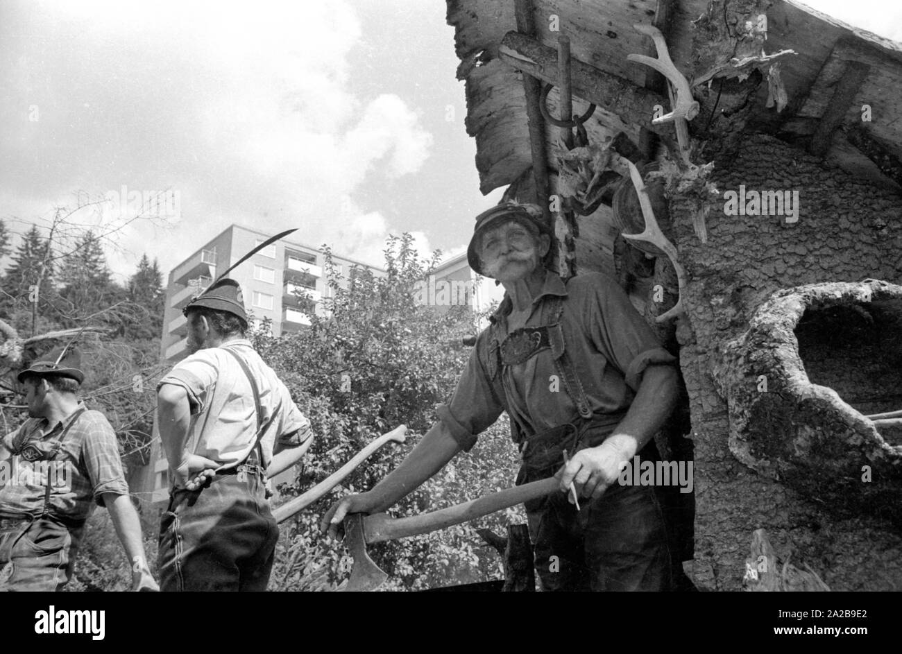 Durante la tradizionale sfilata in costume in Alta Baviera lavori forestali è mostrato su un carrello. Foto Stock