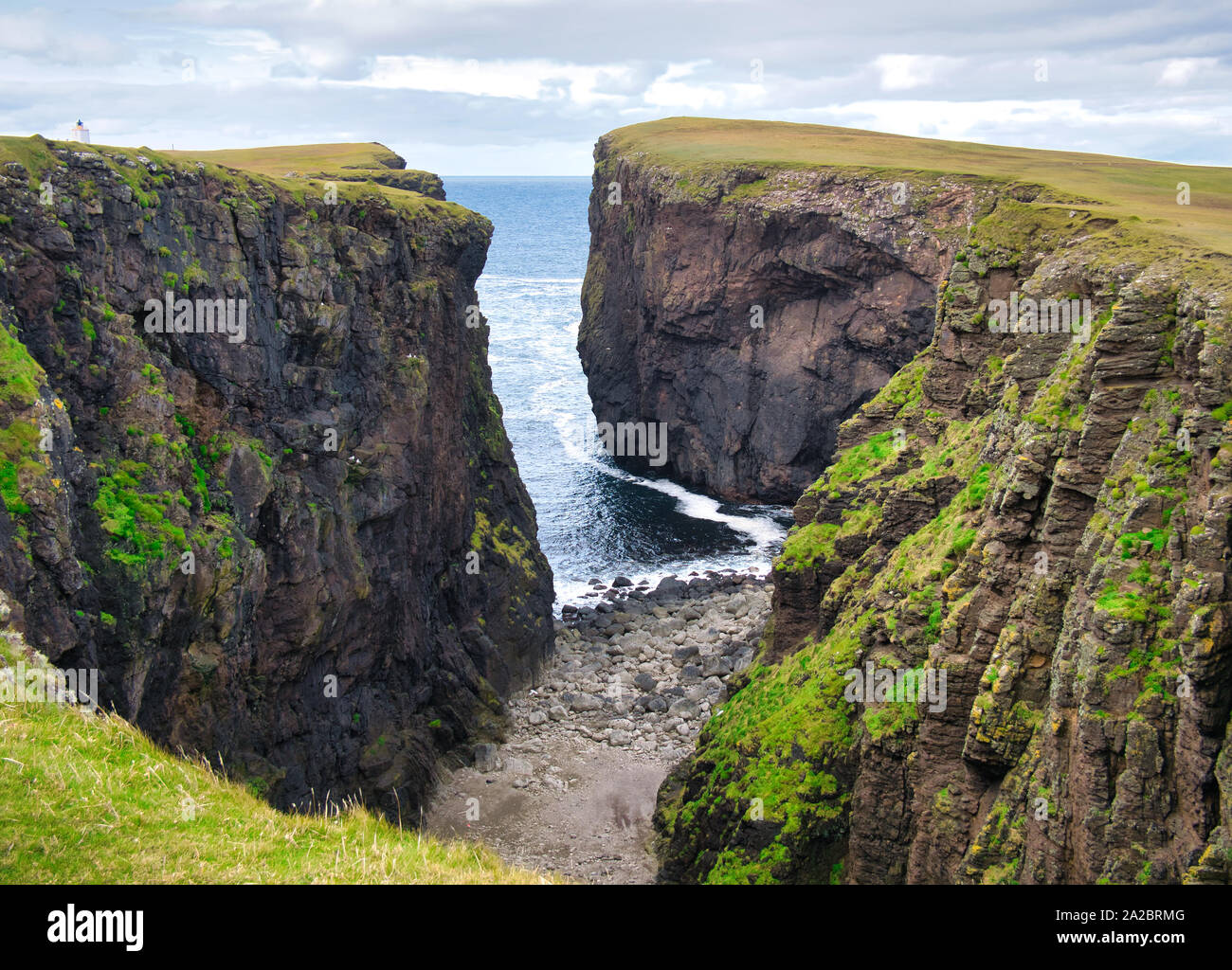 Calder's Geo - un ingresso - su Eshaness, Shetland, Regno Unito - La roccia è di Eshaness formazione vulcanica - piroclastiche-breccia - roccia ignea. Foto Stock