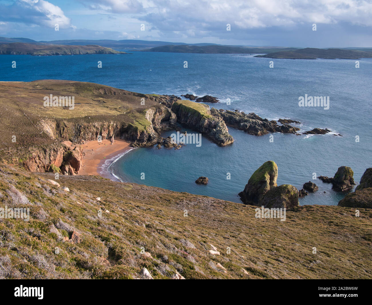 Un deserte e inaccessibili spiaggia sull'isola di sindrome di Muckle Roe sulle isole Shetland, Regno Unito - anche su questa spiaggia remota, rifiuti di plastica può essere visto da una distanza. Foto Stock