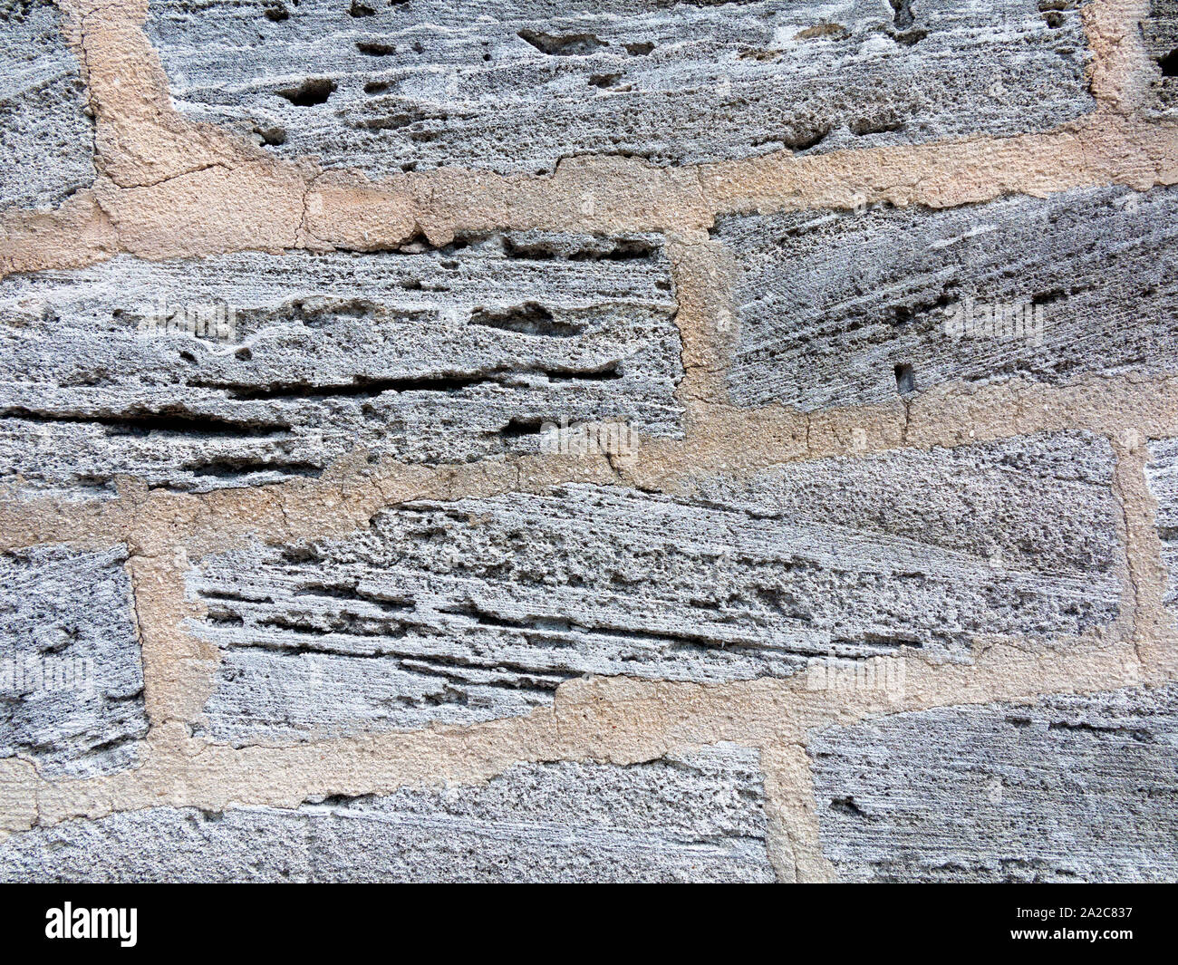 Parete costruita di pietra vulcanica locale in Bermuda Foto Stock