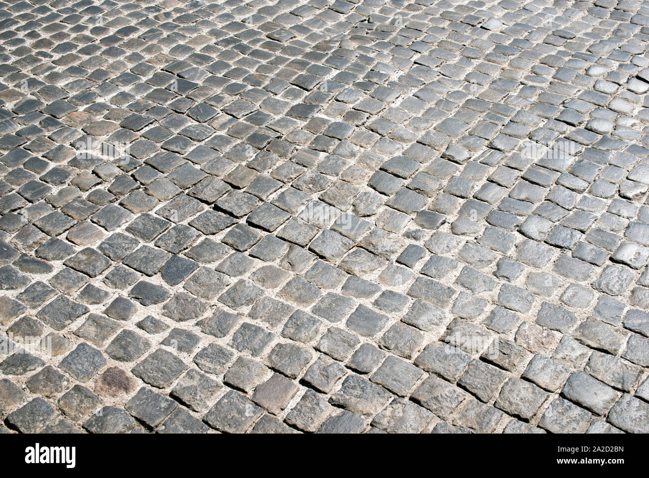 Antica cobblestone pavement pattern in Varsavia dal luminoso giorno Foto Stock