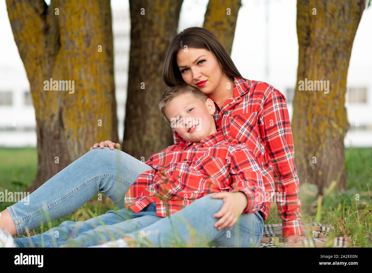 Madre e figlio seduti sul copriletto avvolgente. Foto Stock