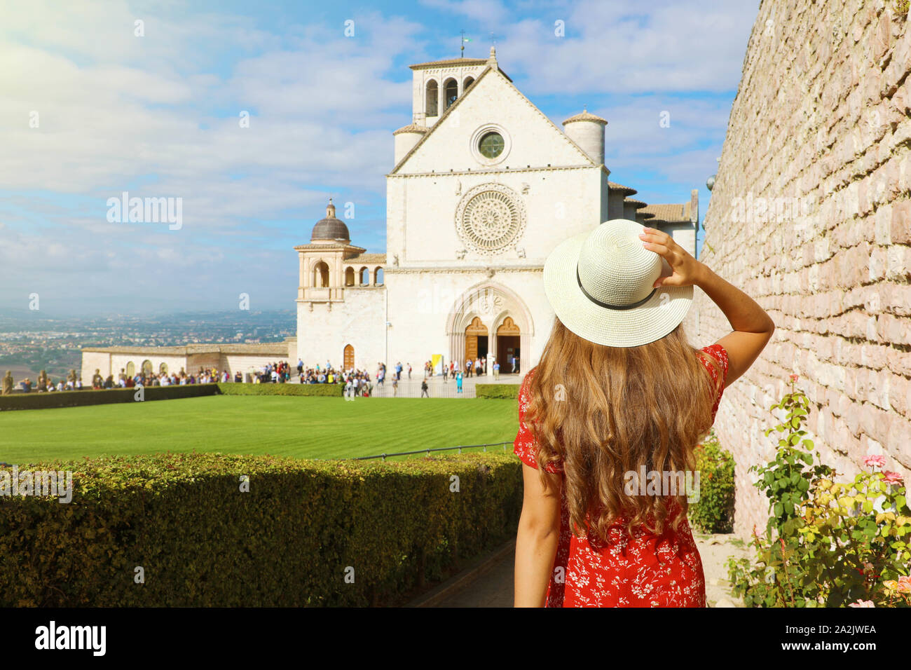 Vacanze in Italia Vista posteriore della bella ragazza a visitare la Basilica di San Francesco di Assisi in Umbria, Italia. Foto Stock