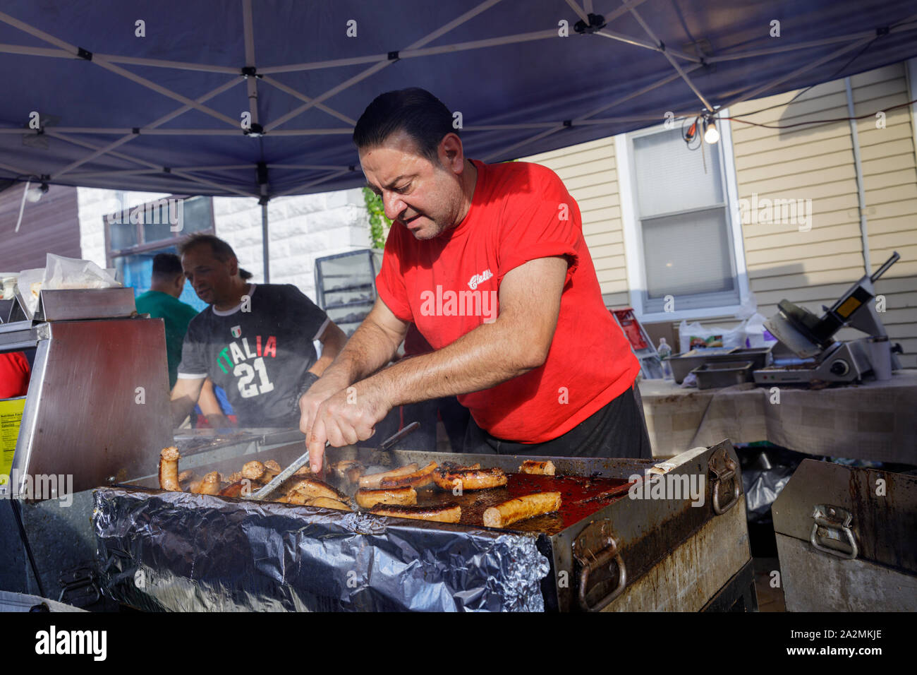 Festival italiano, Schenectady, New York: Uomo salsiccia di cottura sulla griglia. Foto Stock