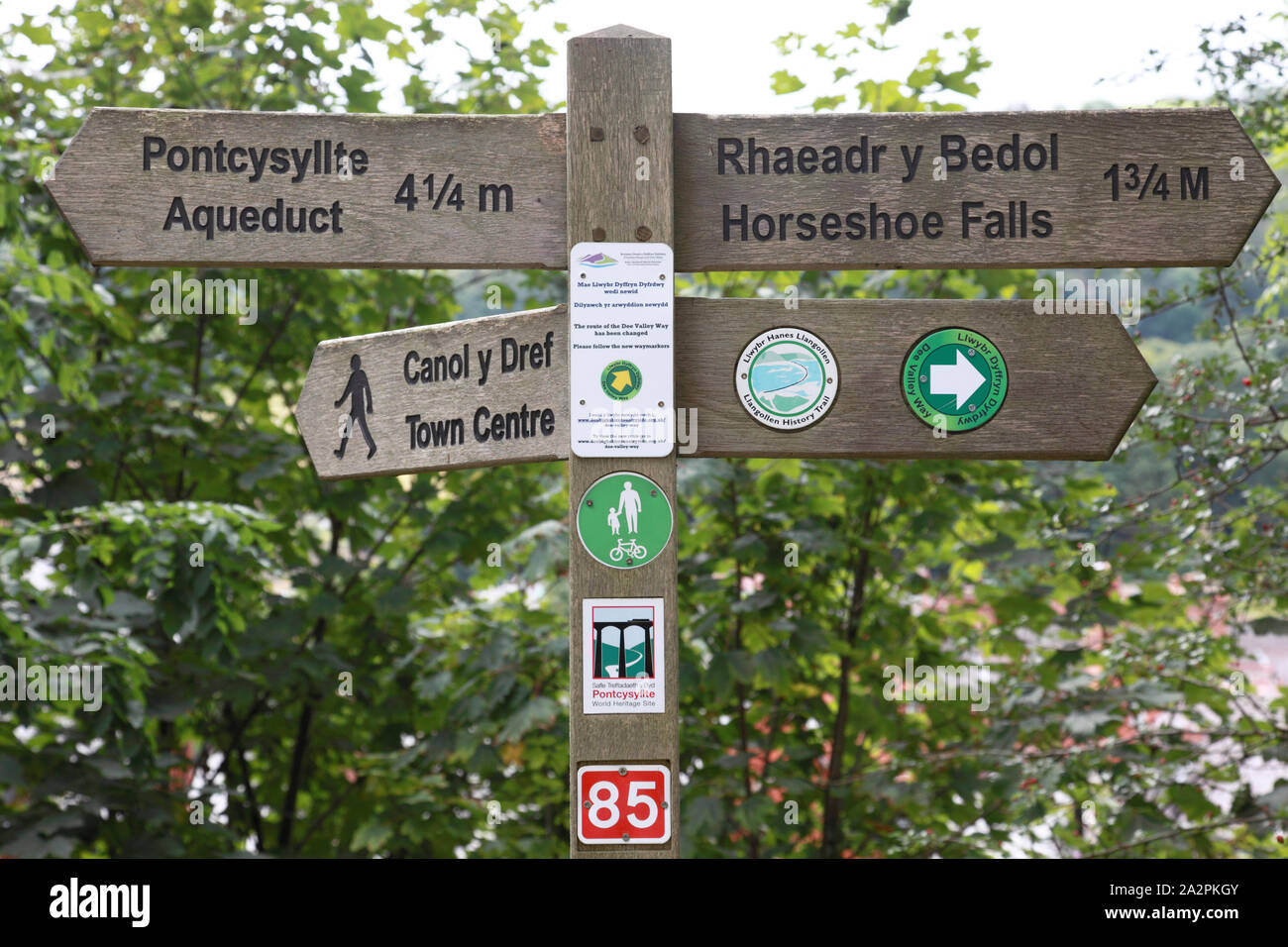 Un segno sulla strada alzaia del Llangollen canal a Llangollen per indicare distanze a piedi alle attrazioni locali Foto Stock