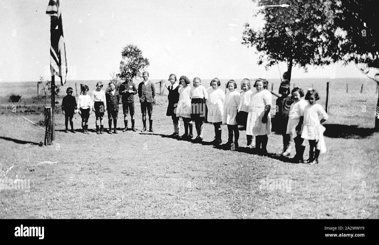 Negativo - Perenna, Victoria, 1925 bambini a Perenna scuola statale si sono riuniti intorno ad un pennone con la bandiera a metà il montante per la morte della regina Alexandra Foto Stock