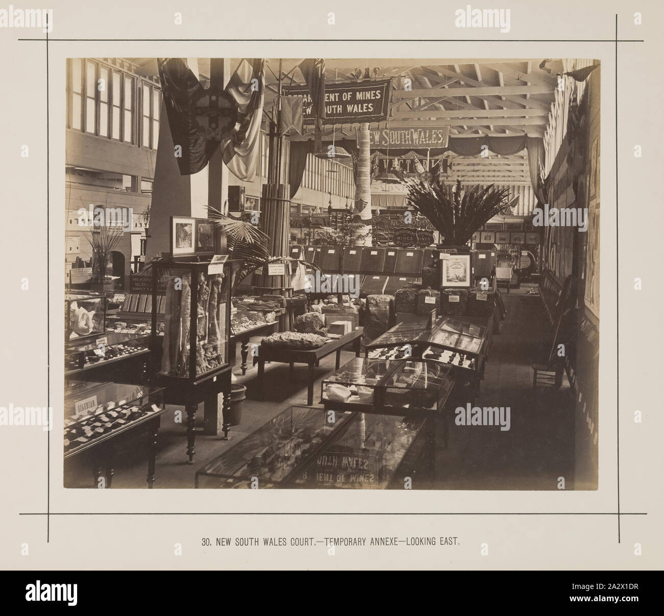 Fotografia - New South Wales corte, temporanea allegato, Exhibition Building, 1880-1881, vista guardando verso est da vicino all'ingresso del Nuovo Galles del Sud in corte centrale allegato temporanee sul lato est del viale principale a 1880 Melbourne Mostra Internazionale tenutasi presso la mostra gli edifici, giardini Carlton, tra il 1 ottobre 1880 e 30 aprile 1881. In aggiunta alla principale mostra permanente edificio, due allegati permanente nonché un grande e centrale in legno Foto Stock