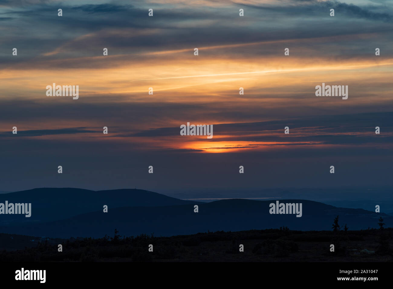 Tramonto con nuvole,cielo colorato e Smrk con Stog Izerski collina di Jizerske hory montagne dal piano Vysoka hill nelle montagne di Krkonose Foto Stock