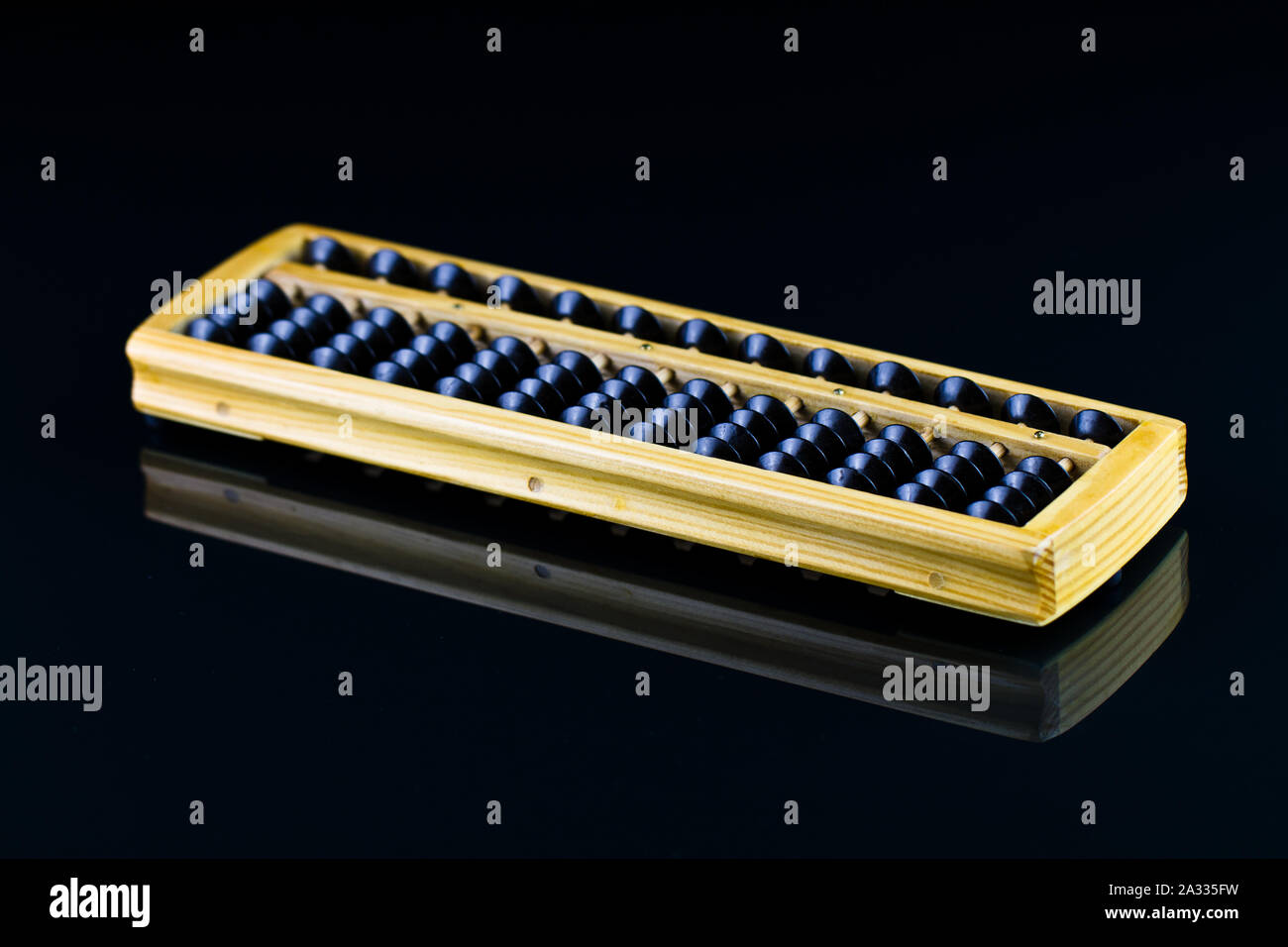 Abacus con perle nero su nero superficie riflettente Foto Stock