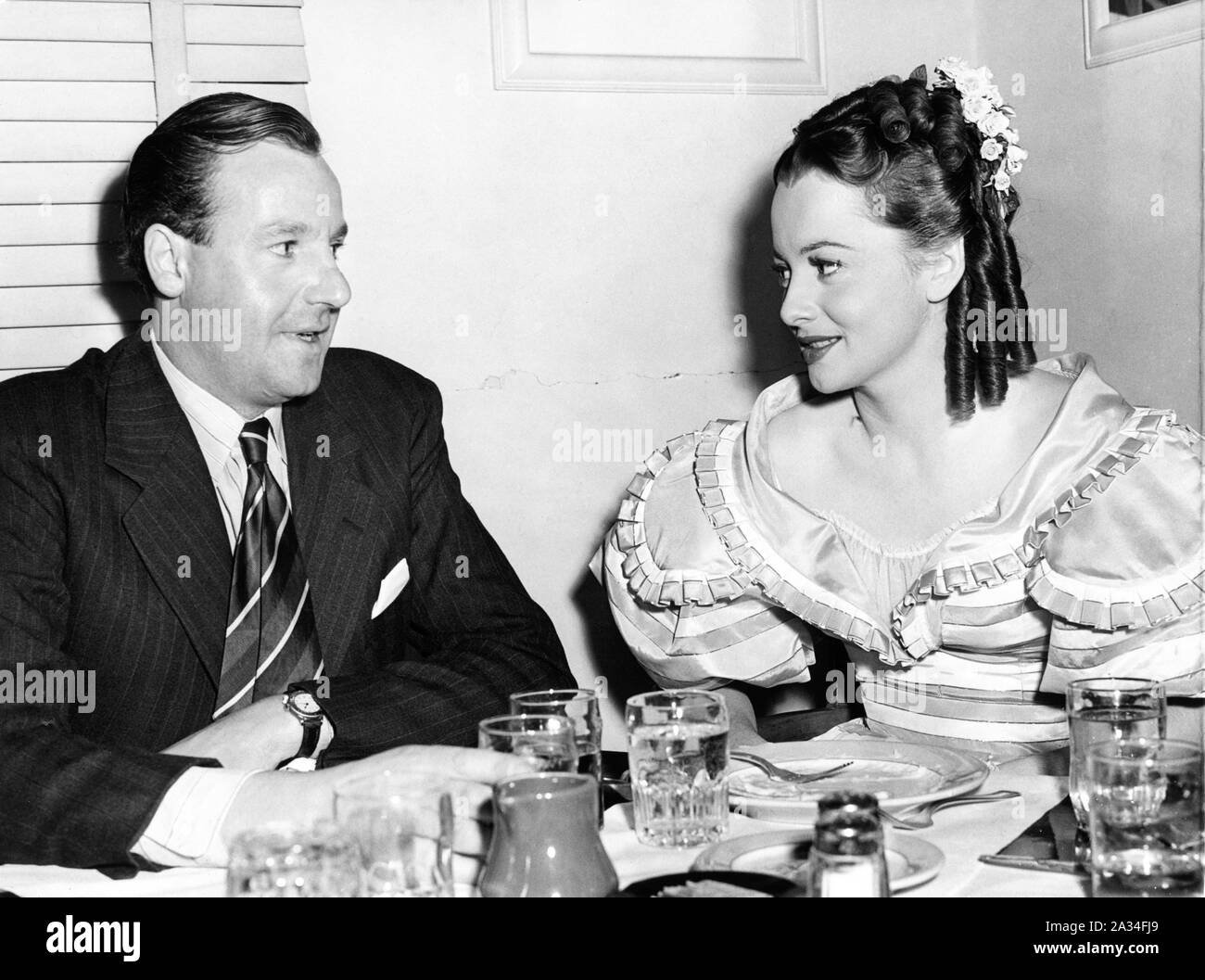 OLIVIA de Havilland candida in costume come CHARLOTTE BRONTE con la cugina Lt. GEOFFREY de Havilland presso lo Studio ristorante durante le riprese di devozione nel dicembre 1942 Warner Bros Foto Stock