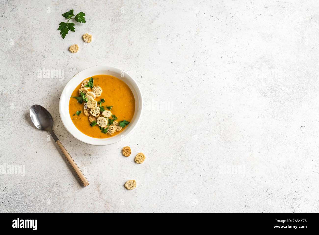 Zuppa di verdure e rabboccato con crostini e prezzemolo nel recipiente su sfondo bianco, vista dall'alto, copia dello spazio. Sana dieta stagionale del cibo vegetariano - così fatti in casa Foto Stock