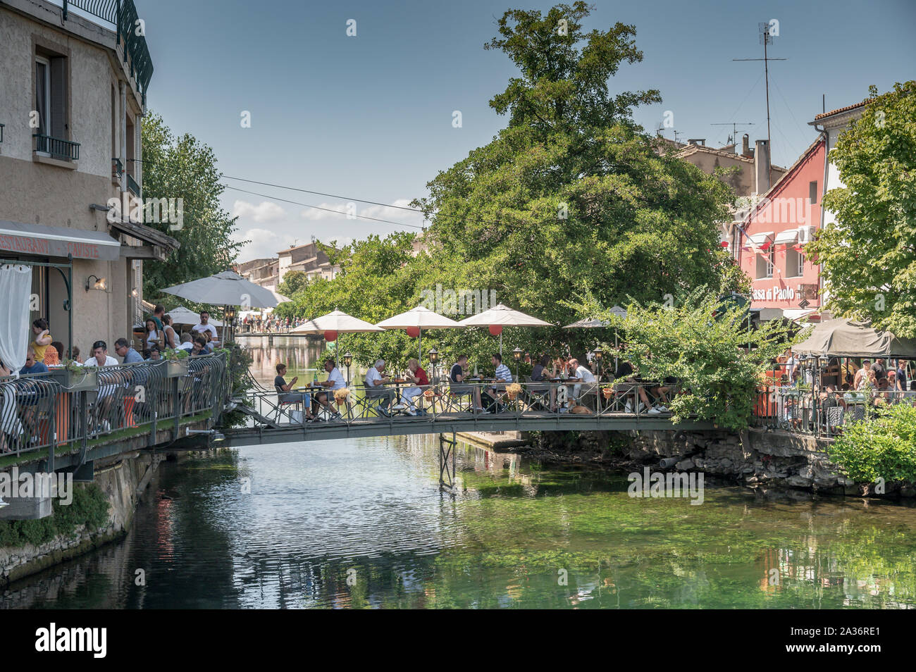 L'Isle sur la Sorgue, Francia / 18 SEP 2019: Unidentified diners godendo il brunch domenicale in un caffè all'aperto su un ponte sopra il fiume Sorgue collaudate Foto Stock