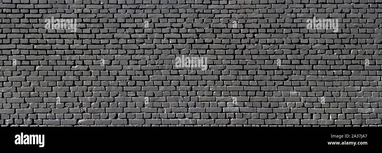 Muro nero come sfondo, la texture di un nero parete di mattoni Foto Stock
