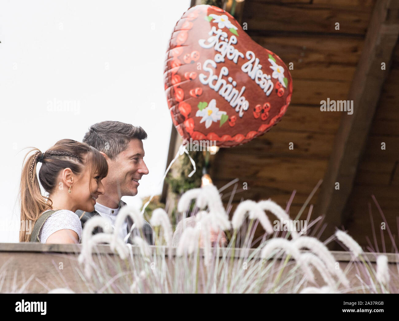 Monaco di Baviera, Germania. 06 ott 2019. Robert Lewandowski e sua moglie Anna Lewandowska stessi hanno fotografato su un balcone da lo scarabeo tenda al Oktoberfest sulla Theresienwiese. I giocatori, allenatori e dirigenti della Bundesliga squadra di calcio FC Bayern tradizionalmente visitare la tenda Käfer insieme una volta durante l'Oktoberfest. Credito: Matthias esitano di fronte/dpa/Alamy Live News Foto Stock
